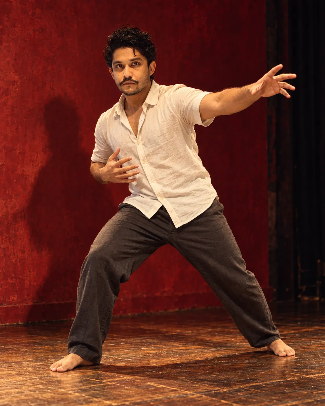 Artistic portrait of Saran in an expressive full-body theatre pose